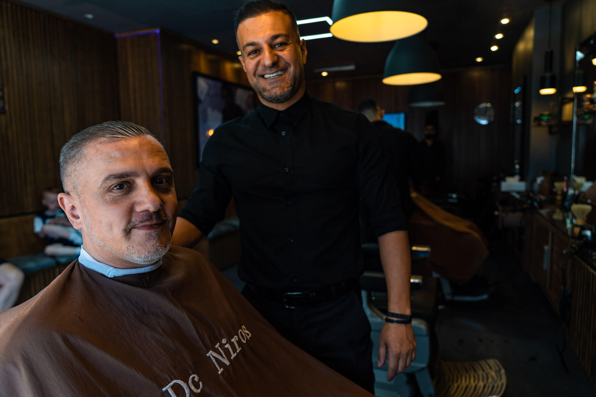 DeNiro's Barbers Expert Team with Satisfied Client